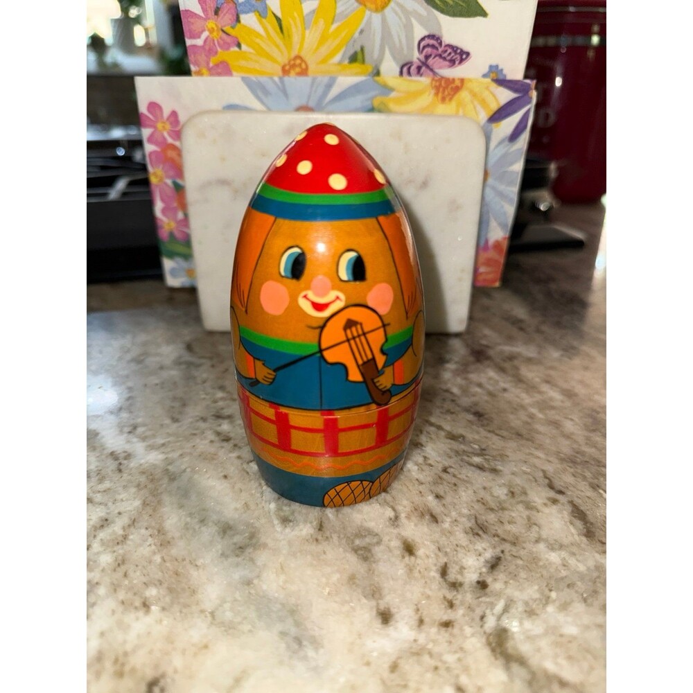 vintage Russian Matryoshka doll, uniquely shaped like an egg and hand-painted wi